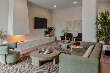 A living room with a green couch and a coffee table.